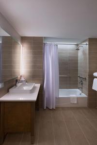 a bathroom with a tub and a sink and a shower at Element Spring Valley in Spring Valley