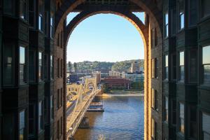 an archway over a river between two buildings at Renaissance Pittsburgh Hotel in Pittsburgh