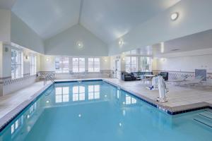 a swimming pool in a large room with a pool at Residence Inn South Bend Mishawaka in South Bend