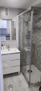 a bathroom with a glass shower and a sink at EL ESTUDIO DE LA PLAYA BENALBEACH 804 Holidays Paradise in Benalmádena