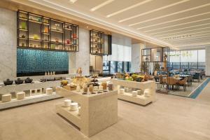 a lobby of a hotel with a table with food at Fairfield by Marriott Mumbai International Airport in Mumbai