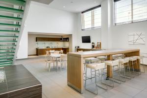 a kitchen and dining room with a bar and stools at Element Omaha Midtown Crossing in Omaha