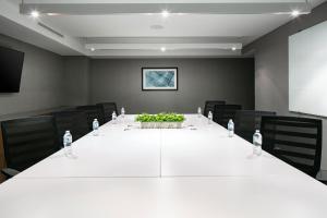 a conference room with a large white table and chairs at Element Omaha Midtown Crossing in Omaha