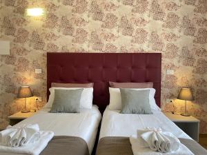 A bed or beds in a room at Porta alla Croce Guest House