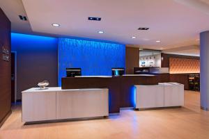 a lobby with a blue wall and two counters at Fairfield Inn & Suites by Marriott La Crosse Downtown in La Crosse