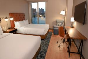 a hotel room with two beds and a desk at Four Points by Sheraton Mexico City Colonia Roma in Mexico City