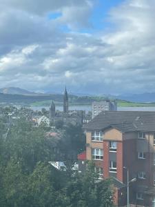 a view of a city with a clock tower at Spacious one bedroom flat, entire property. in Greenock