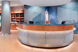a lobby with a circular counter in a pharmacy at SpringHill Suites by Marriott Atlanta Airport Gateway in Atlanta
