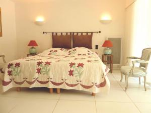 ein Schlafzimmer mit einem großen Bett und einem Stuhl in der Unterkunft Charming cocoon 100sqm for 4p with infinity pool in Châteauneuf