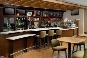 a bar in a restaurant with chairs and tables at Courtyard by Marriott Wichita Falls in Wichita Falls