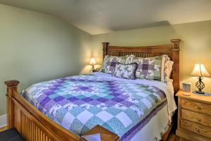 a bedroom with a bed with a blue and purple quilt at Serene Tacoma Home with Furnished Deck and Views! in Tacoma