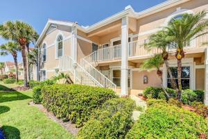a large house with palm trees and bushes at Bonita Springs Condo with Pool, Near Beaches! in Bonita Springs