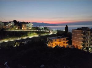 a view of a city at night with buildings at AL Hotel in Vlorë