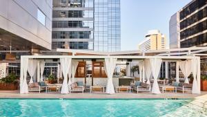 a hotel pool with chairs and a gazebo at Kimpton Hotel Palomar Phoenix Cityscape, an IHG Hotel in Phoenix
