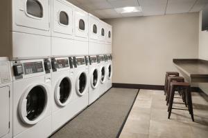 a laundry room with a row of washing machines at TownePlace Suites by Marriott New Orleans Downtown/Canal Street in New Orleans