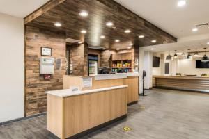 a restaurant lobby with a counter and a kitchen at Fairfield by Marriott Inn & Suites Greensboro Coliseum Area in Greensboro