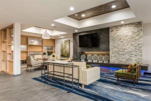a living room with a stone wall at Fairfield by Marriott Inn & Suites Greensboro Coliseum Area in Greensboro