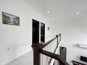 a staircase with white walls and a picture on the wall at Escape from stress & noise! in Roatan