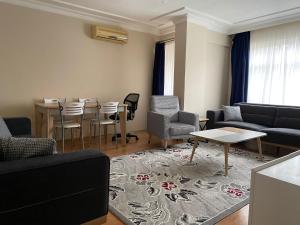 a living room with a couch and a table and chairs at 3+1 stylish furnished and spacious apartment in the center of Istanbul in Istanbul