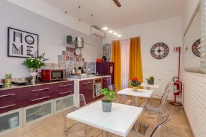 a kitchen with purple cabinets and a white table and chairs at St. Peter's Relax in Rome +27 photos