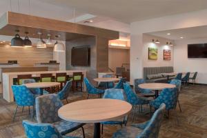 a dining room with tables and blue chairs at Fairfield Inn & Suites by Marriott Spokane Valley in Spokane Valley