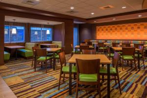 a dining room with tables and chairs at Fairfield Inn & Suites by Marriott St. Louis Westport in Maryland Heights