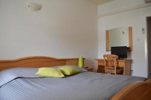 a bedroom with a bed with a yellow pillow on it at Guest House Kolarin in Slano