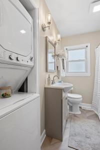 a white bathroom with a sink and a toilet at Isla's Landing in Lexington