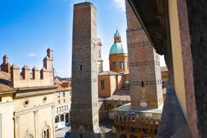 a view of a city with two tall towers at Albergo Garisenda in Bologna