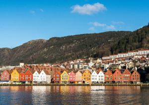 a row of colorful houses on the shore of a body of water at Bergen city center apartment in Bergen