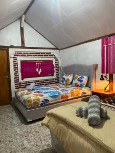 a bedroom with two beds and a window at Wina Wani Bungalows Tetebatu in Tetebatu