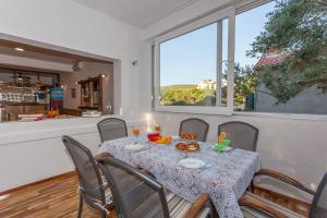 a dining room with a table and chairs and a window at Amazing Villa Grande with swimming pool in Sveti Petar