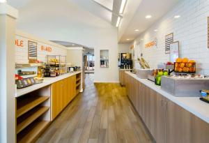 a kitchen with a counter with fruits and vegetables at Sonesta ES Suites Fort Worth Fossil Creek in Fort Worth