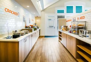 a large kitchen with wooden counter tops in a restaurant at Sonesta ES Suites Atlanta Alpharetta North Point Mall in Alpharetta