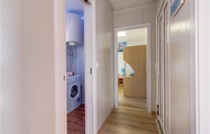 a hallway with a washer and dryer in a house at Amazing Home In Nerezine With Outdoor Swimming Pool in Nerezine