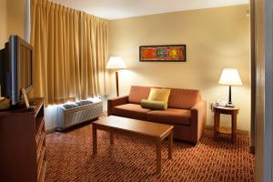 a hotel room with a couch and a tv at TownePlace Suites Wilmington Newark / Christiana in Newark