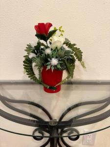 a red vase with flowers sitting on a shelf at NEW Private House B with Carports EV Plugin L2 in Twin Falls
