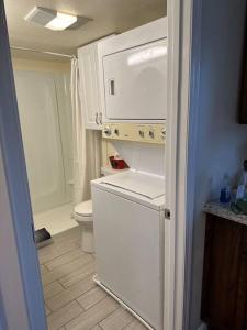 a small kitchen with a white refrigerator and a toilet at NEW Private House B with Carports EV Plugin L2 in Twin Falls