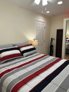 a bedroom with a large bed with striped pillows at NEW Private House B with Carports EV Plugin L2 in Twin Falls