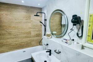 a bathroom with a sink and a mirror at Luxury VIP apartment in Cairo