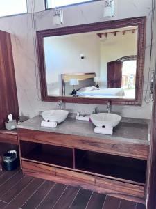 a bathroom with two sinks and a large mirror at La Buena Vibra Retreat and Spa Hotel Adults Only in Tepoztlán