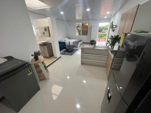 a kitchen with a refrigerator and a counter top at apartaestudios las astromelias Armenia in Armenia