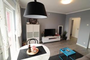 a living room with a table and a black lamp at Apartments with WiFi Sibenik - 20831 in Šibenik