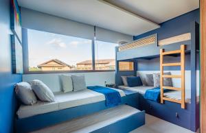 two bunk beds in a room with a window at Casa em Carneiros - 4 suítes com piscina in Tamandaré +70 photos