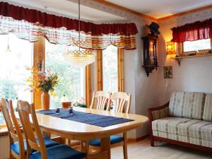 a dining room with a table and chairs and a couch at Holiday home Grebbestad X in Grebbestad