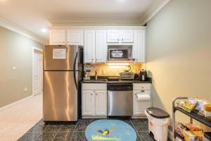 a kitchen with a stainless steel refrigerator and white cabinets at Private Master Room Downtown Atlanta in Atlanta