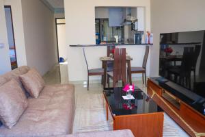 a living room with a couch and a table at Grey Hound Vacation Home in Vipingo