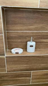 a soap dispenser sitting on a shelf in a bathroom at Moderno Departamento Paseo la Cortadura en Tampico in Tampico