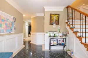 a home hallway with a staircase with a shelf at City Chic Private Room & Bath in Atlanta
