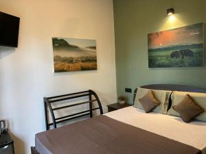 a bedroom with a bed and a picture of elephants at Star Gaze Lodge in Ella